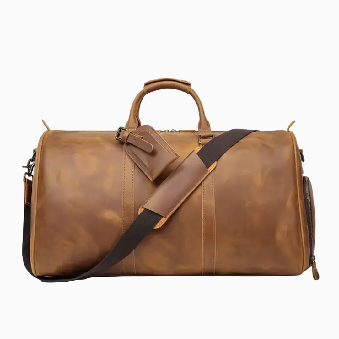 Brown leather duffel bag with a shoulder strap on a white background
