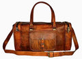 Brown leather duffel bag with gold hardware on a white background